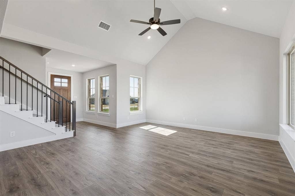 410 Rancher Trail, Waxahachie, TX 75165 Vaulted ceiling with a ceiling fan, recessed lighting, wood-finish flooring, and multiple windows