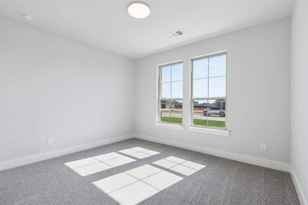 410 Rancher Trail, Waxahachie, TX 75165 Light gray carpeted flooring, white painted walls, and twin double-hung windows