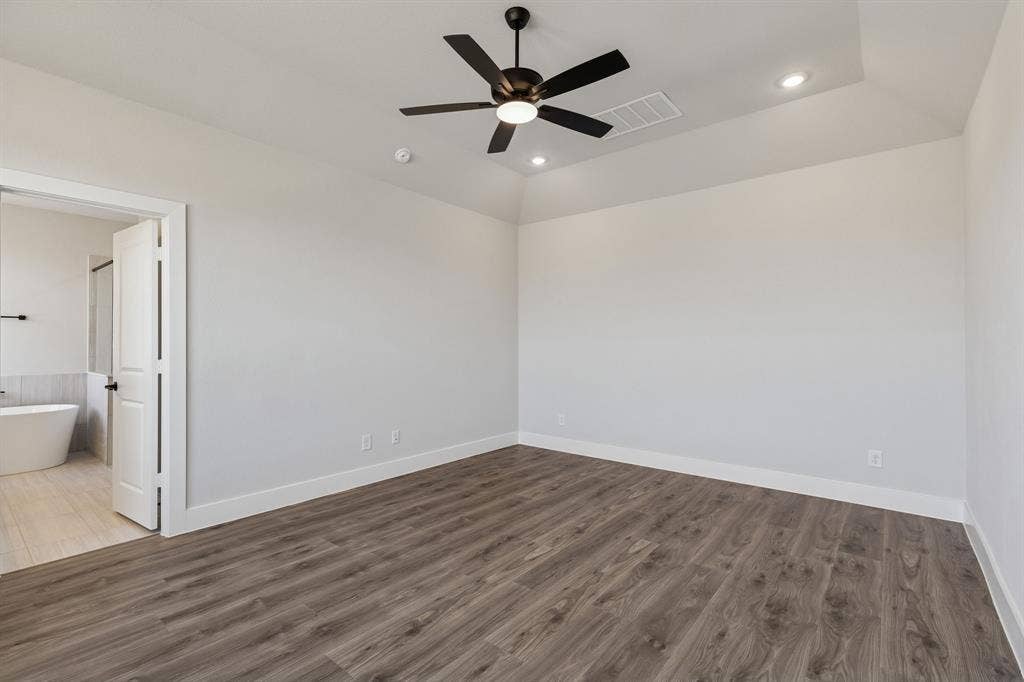 410 Rancher Trail, Waxahachie, TX 75165 Wood-finish flooring with a neutral wall palette
