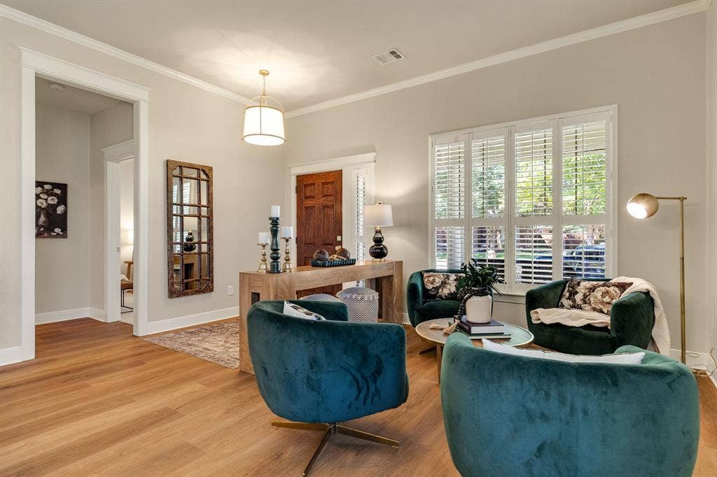 630 Candlewood Trail, Murphy, TX 75094 Light wood-finish flooring with white baseboards and crown molding