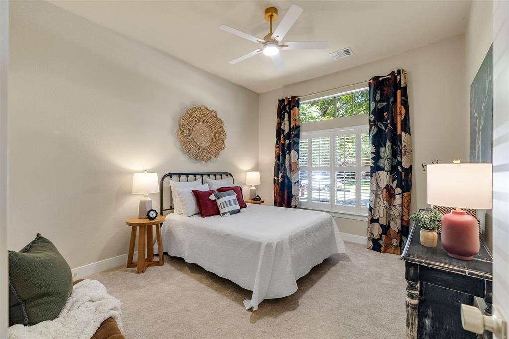 630 Candlewood Trail, Murphy, TX 75094 Recessed ceiling with an integrated fan and light fixture, window with plantation shutters and decorative curtains, and light-toned carpeting