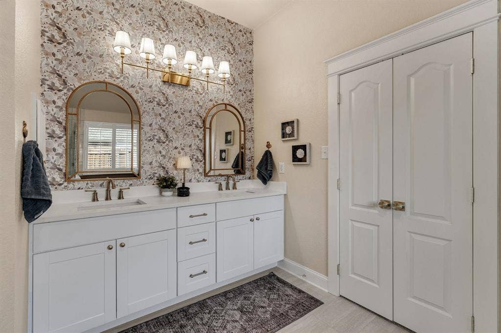 630 Candlewood Trail, Murphy, TX 75094 Double vanity with white cabinetry and integrated sinks