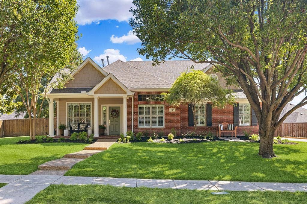 630 Candlewood Trail, Murphy, TX 75094 Brick and siding exterior with a covered front porch featuring white columns