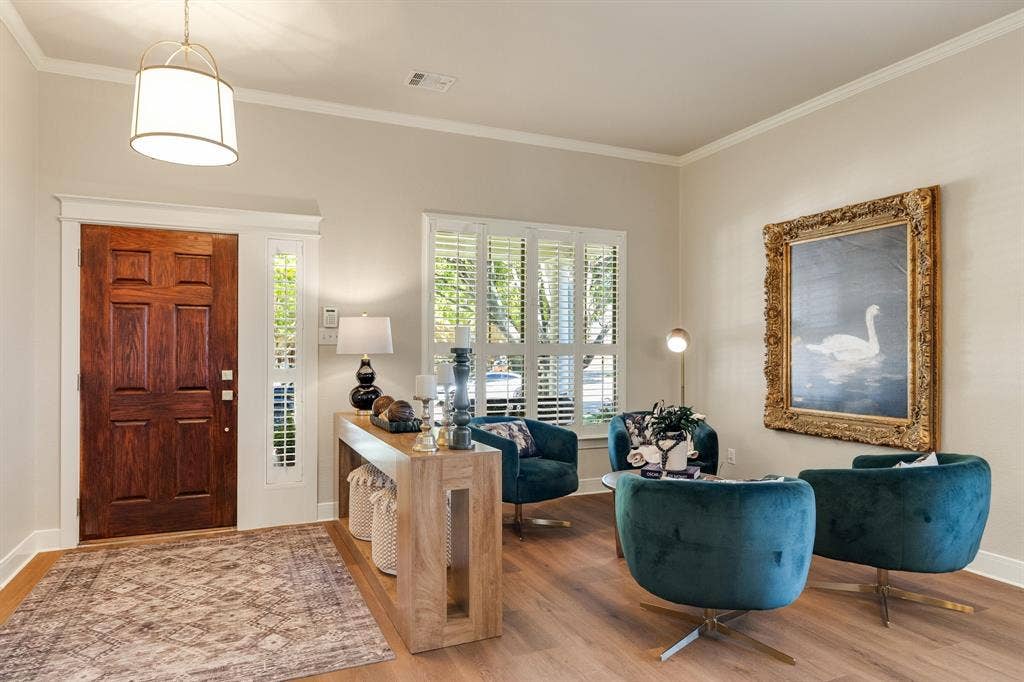 630 Candlewood Trail, Murphy, TX 75094 Wood-finish flooring, crown molding, and a solid wood entry door with sidelight