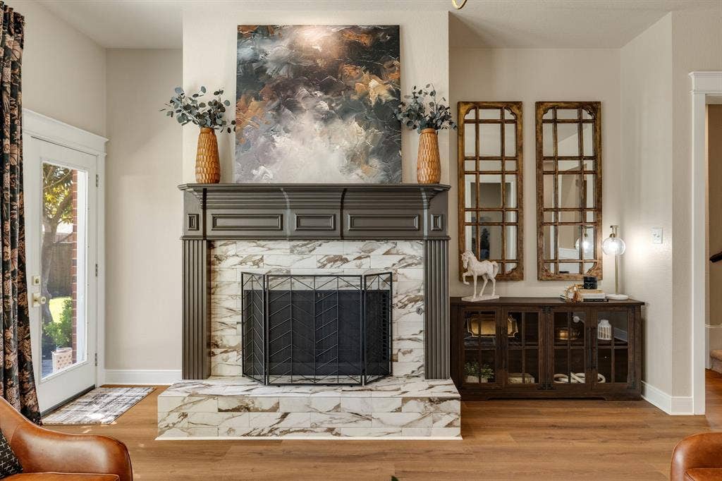 630 Candlewood Trail, Murphy, TX 75094 Fireplace with dark wood mantel and decorative tile surround