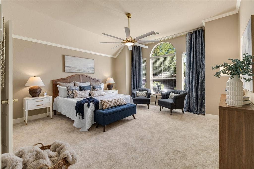 630 Candlewood Trail, Murphy, TX 75094 Vaulted ceiling with crown molding, ceiling fan, and arched windows