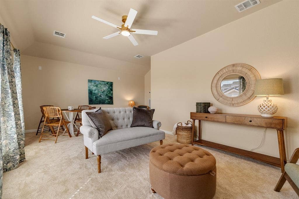 630 Candlewood Trail, Murphy, TX 75094 Open-concept living space with neutral tone walls, high vaulted ceilings, and a ceiling fan with light fixture