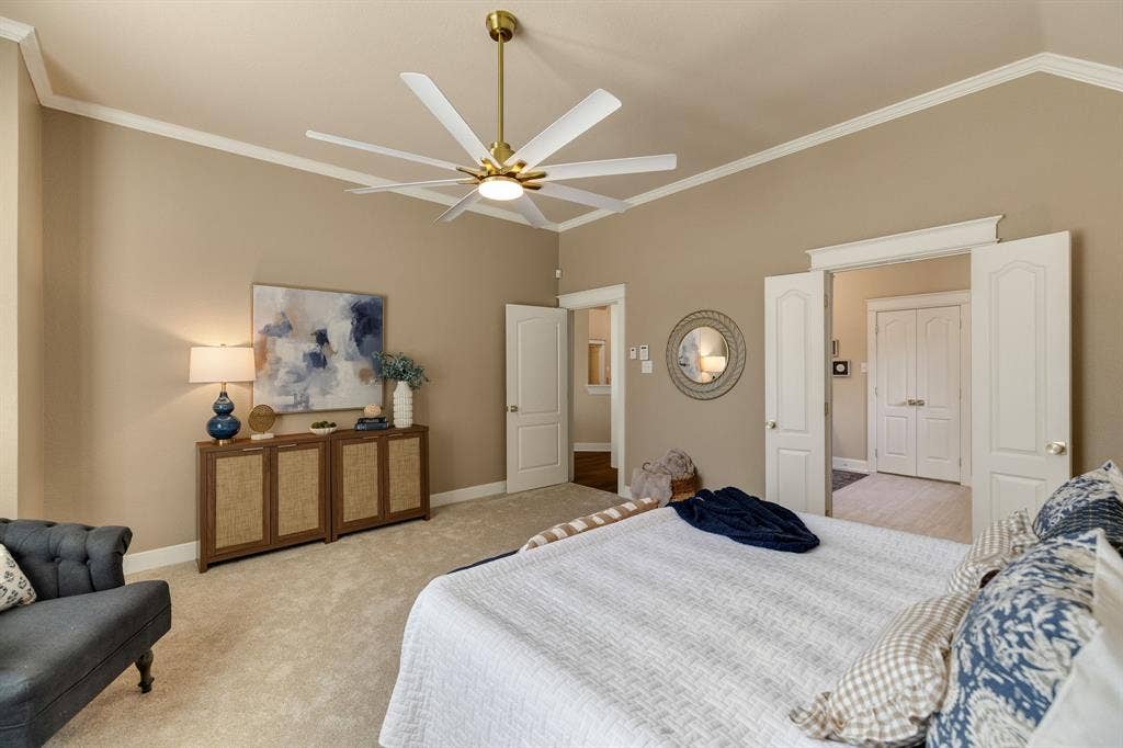 630 Candlewood Trail, Murphy, TX 75094 Vaulted ceiling with crown molding, ceiling fan with brushed gold accents, plush carpet flooring, and paneled interior doors