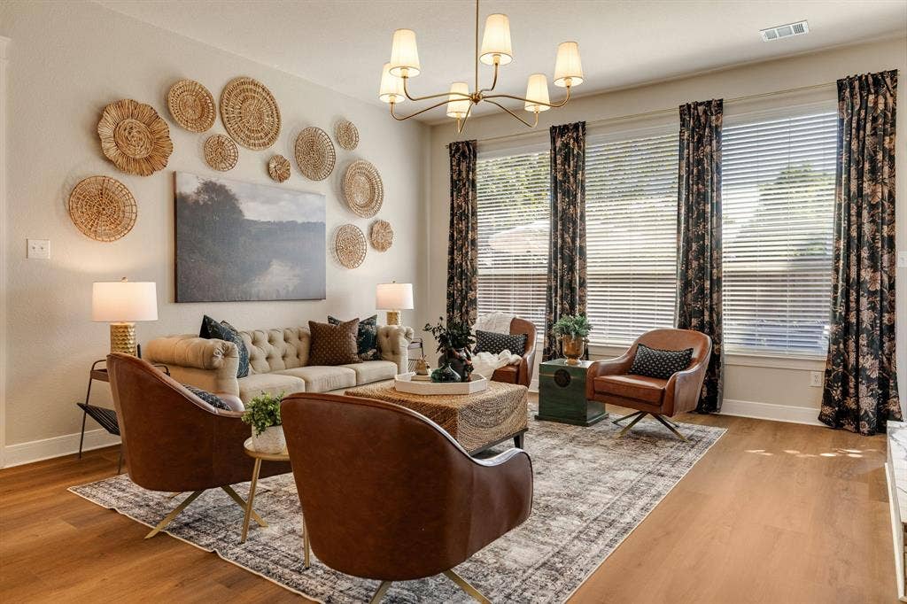 630 Candlewood Trail, Murphy, TX 75094 Bright living area featuring wood-finish flooring, multiple windows, and a multi-arm ceiling light fixture