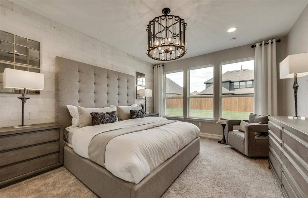 2816 southampton Drive, McKinney, TX 75071 Wall-to-wall carpeting, three large windows, a decorative chandelier, and a shiplap accent wall