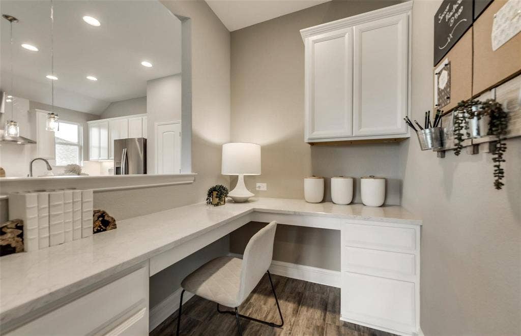 2816 southampton Drive, McKinney, TX 75071 Built-in desk with a light-toned countertop, white cabinetry, and wood-finish flooring