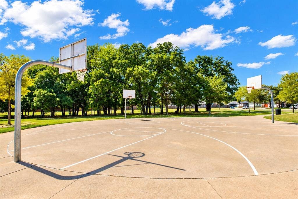Outdoor basketball court featuring multiple hoops