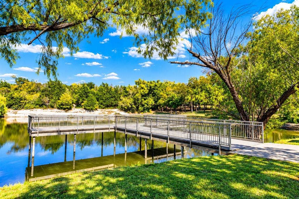 Waterfront pier with metal railings and a concrete path