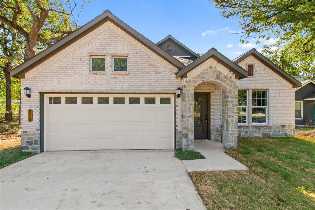 7520 Double Bridge Road, Mabank, TX 75156 Brick and stone exterior with a covered entry, attached garage, and multiple gables