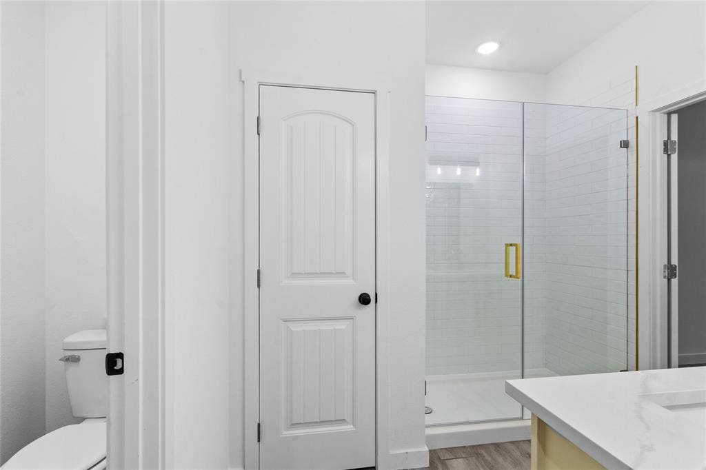 7520 Double Bridge Road, Mabank, TX 75156 Glass-enclosed shower with subway tile surround, white solid-surface countertop, and gold-finish hardware