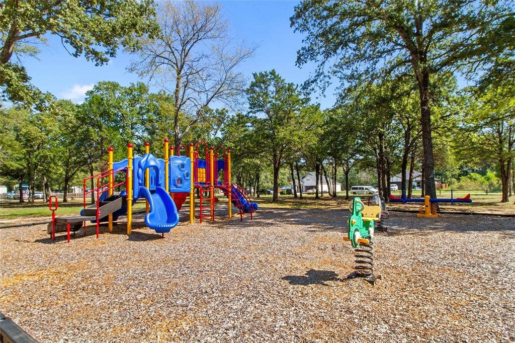 7520 Double Bridge Road, Mabank, TX 75156 Outdoor playground featuring a multi-level play structure, slides, and a spring rider