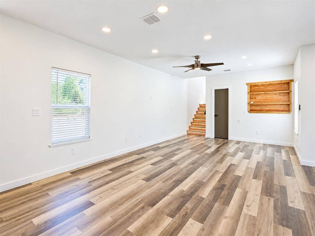 521 York Street, Athens, TX 75751 Wood-finish flooring, recessed lighting, ceiling fan, natural wood built-in shelving, and staircase with wood treads