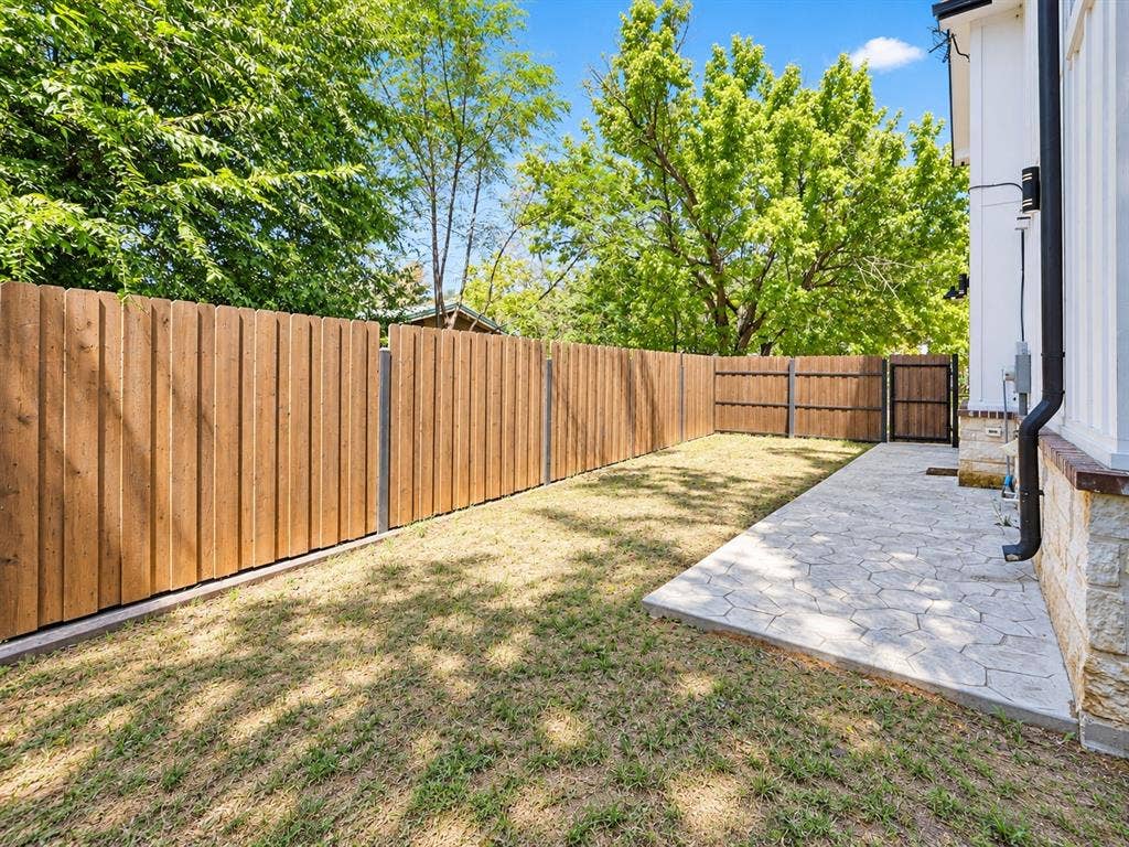 521 York Street, Athens, TX 75751 Private outdoor space with wooden fencing, stamped concrete patio, and mature perimeter trees
