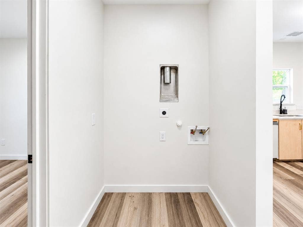 521 York Street, Athens, TX 75751 Dedicated utility space featuring wood-finish flooring and white walls