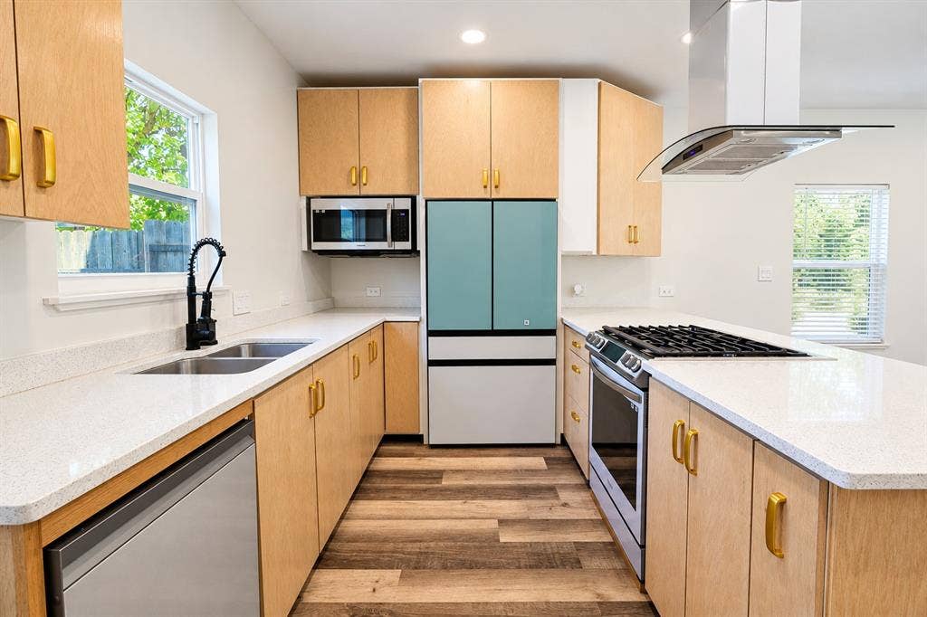 521 York Street, Athens, TX 75751 Kitchen featuring wood-finish cabinetry, light-toned countertops, and wood-finish flooring
