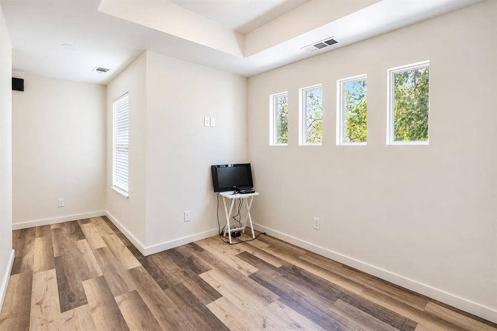 521 York Street, Athens, TX 75751 Wood-finish flooring with a multi-toned pattern, recessed ceiling lighting, and multiple windows