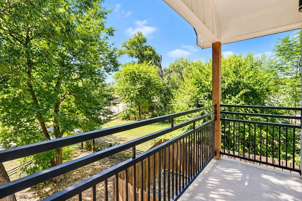 521 York Street, Athens, TX 75751 Private balcony with concrete flooring, black metal railings, and a wood post