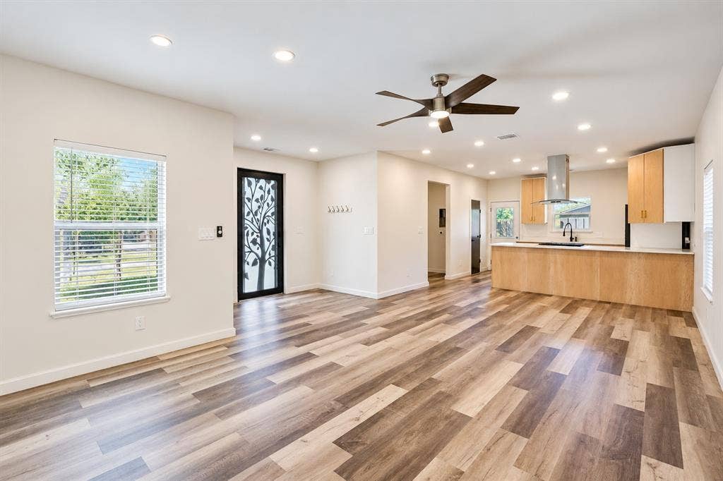 521 York Street, Athens, TX 75751 Recessed lighting throughout, wood-finish flooring, ceiling fan, contemporary kitchen cabinetry, and stainless steel range hood