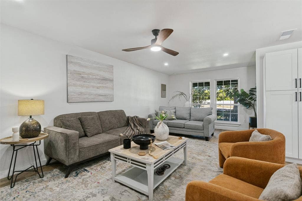 2704 Parkhaven Drive, Plano, TX 75075 Recessed lighting, ceiling fan, multiple windows, built-in cabinetry with dark hardware, and wood-finish flooring