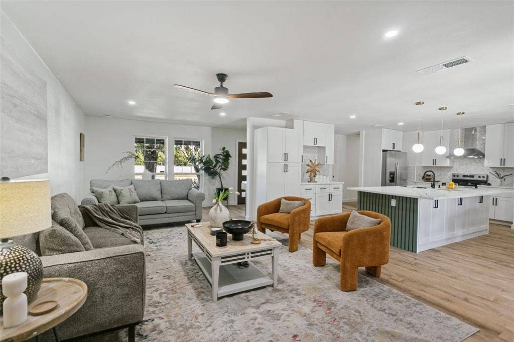 2704 Parkhaven Drive, Plano, TX 75075 Open-concept living space with recessed lighting, wood-finish flooring, and a modern ceiling fan