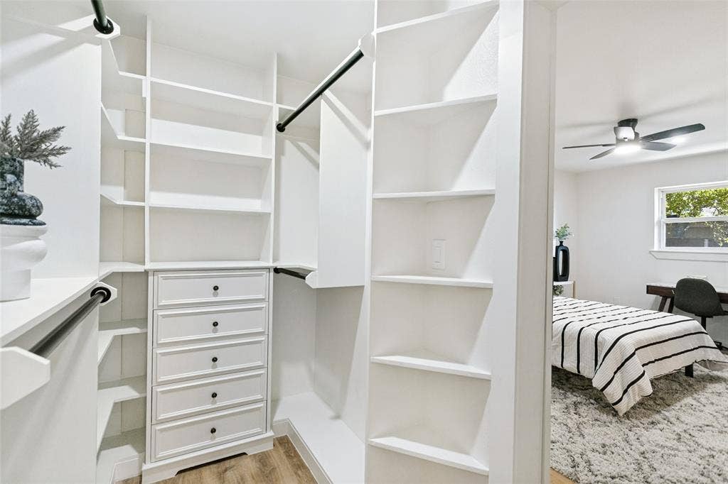 2704 Parkhaven Drive, Plano, TX 75075 Custom closet system featuring built-in shelving, hanging rods, and a five-drawer dresser