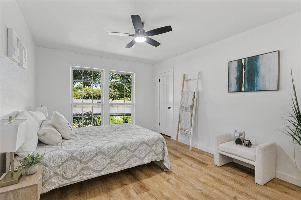 2704 Parkhaven Drive, Plano, TX 75075 Crisp white walls, wood-finish flooring, and a contemporary ceiling fan