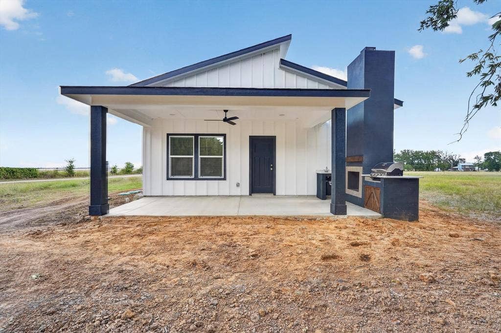102 Shadywood Road, Trinidad, TX 75163 Pitched roofline with dark trim and white vertical siding