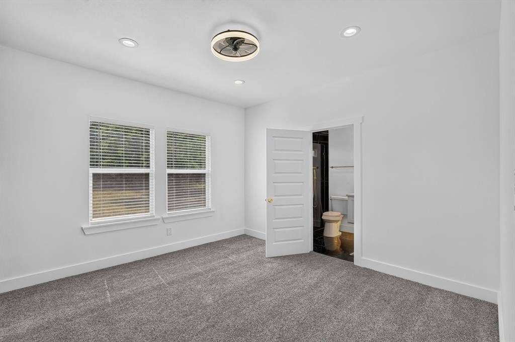 102 Shadywood Road, Trinidad, TX 75163 Recessed lighting, ceiling fan with integrated light, dual windows with blinds, plush gray carpeting, and white paneled door