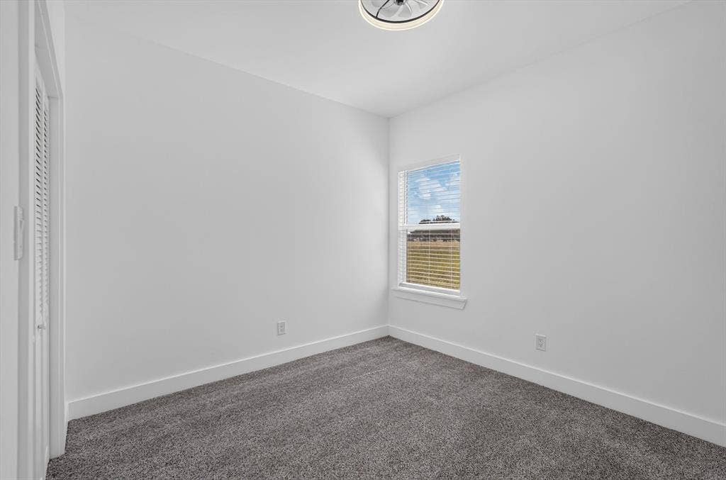 102 Shadywood Road, Trinidad, TX 75163 Neutral wall paint, gray carpet flooring, recessed window, and white window blinds