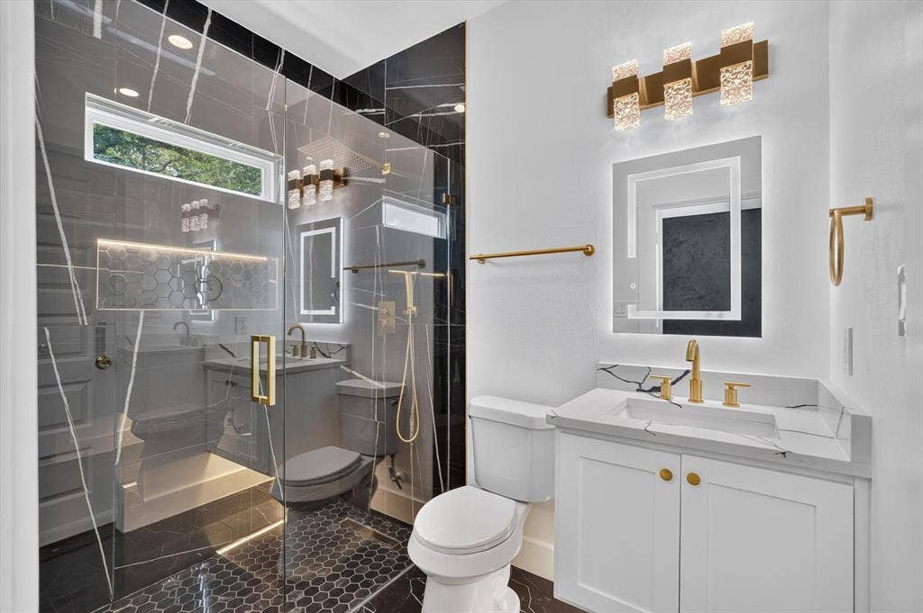 102 Shadywood Road, Trinidad, TX 75163 Walk-in shower with clear glass enclosure and black marble-look tile