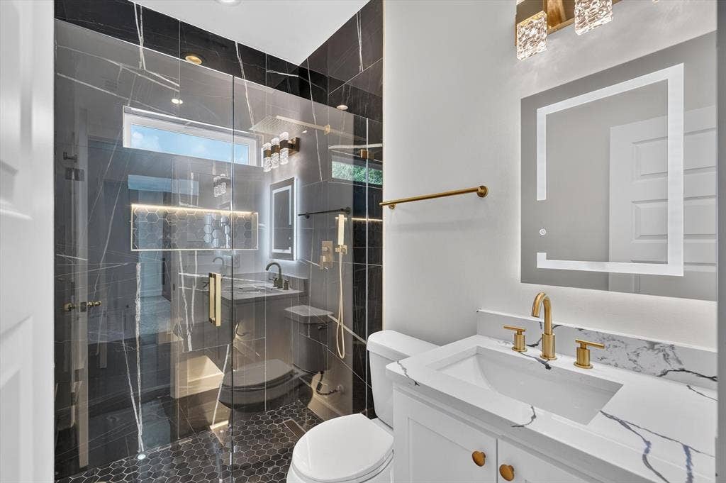 102 Shadywood Road, Trinidad, TX 75163 Walk-in shower with clear glass enclosure and dark-toned tile