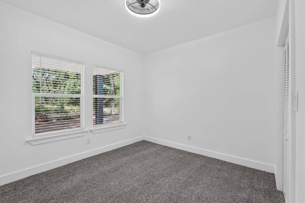 102 Shadywood Road, Trinidad, TX 75163 Bright interior space featuring two windows, recessed lighting, and soft carpet flooring