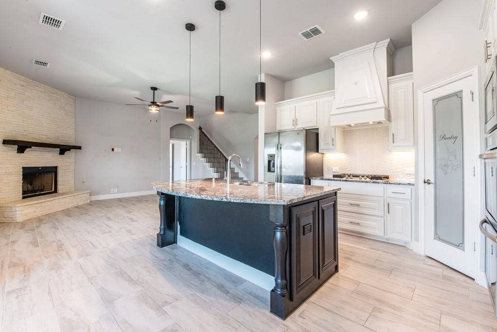 Kitchen island with granite countertop and pendant lighting