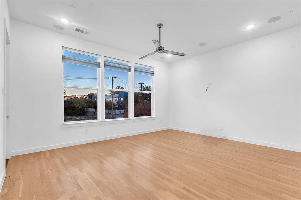 1510 N Washington Avenue, #703, Dallas, TX 75204 Living room in this East Dallas condo with a trio of windows, recessed lighting and a chrome ceiling fan