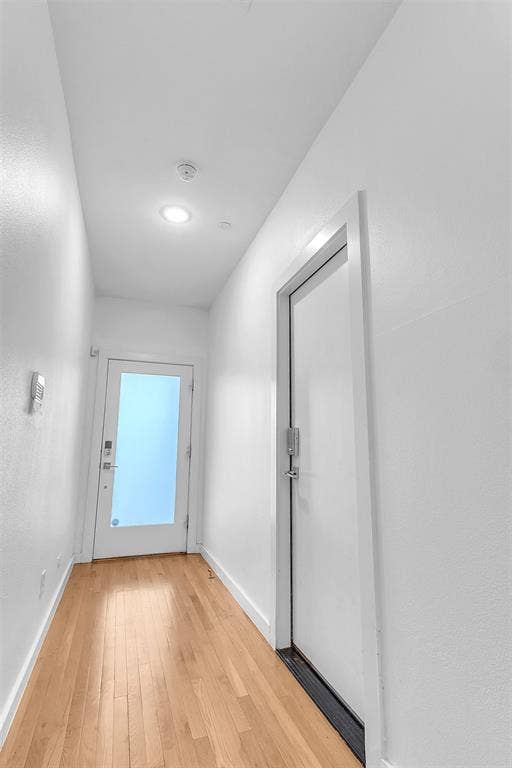 1510 N Washington Avenue, #703, Dallas, TX 75204 First-floor entry hall with wood-look floors, a glass front door with keypad lock and an interior keypad door