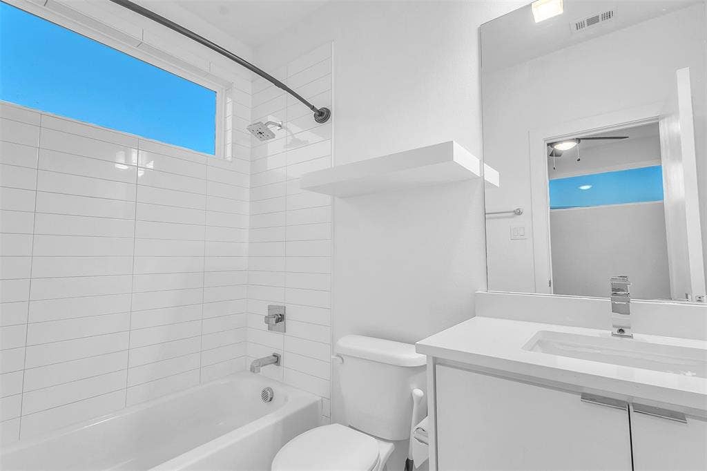 1510 N Washington Avenue, #703, Dallas, TX 75204 Secondary bath with a tub and shower combo, white subway-style tile, a floating shelf and single-sink vanity