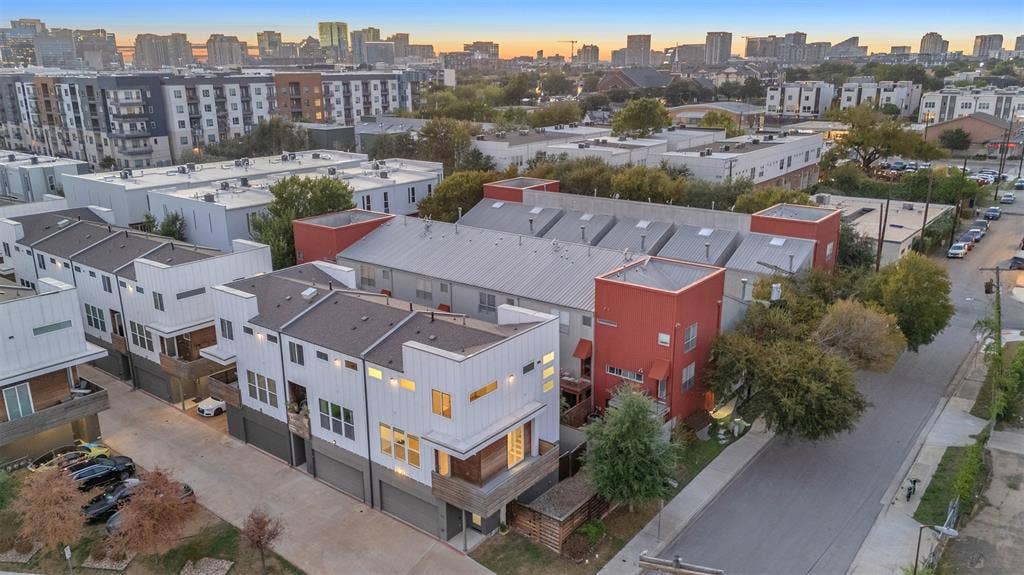 1510 N Washington Avenue, #703, Dallas, TX 75204 Aerial view of the row of condos, the shared garage drive and the surrounding East Dallas neighborhood
