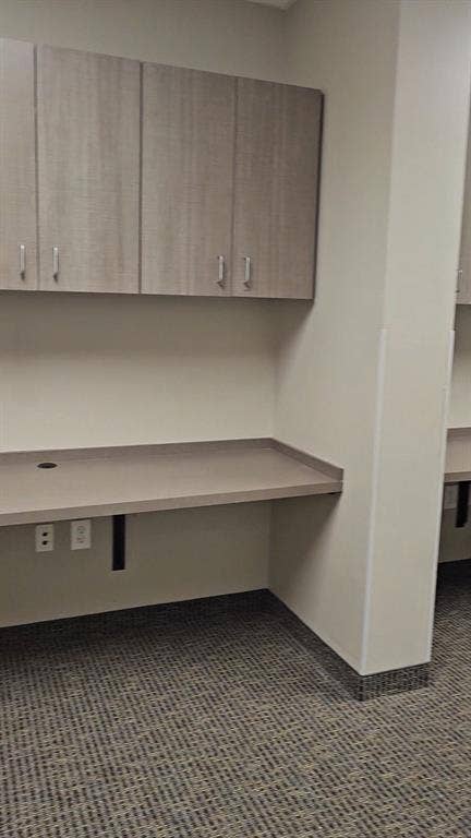 1675 Republic Parkway, #104, Mesquite, TX 75150 Built-in desk with a smooth surface, integrated power outlets, and overhead cabinetry with contemporary hardware
