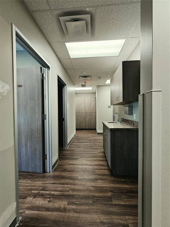 1675 Republic Parkway, #104, Mesquite, TX 75150 Wood-finish flooring, drop ceiling with recessed lighting, built-in cabinetry, and a countertop with an integrated sink
