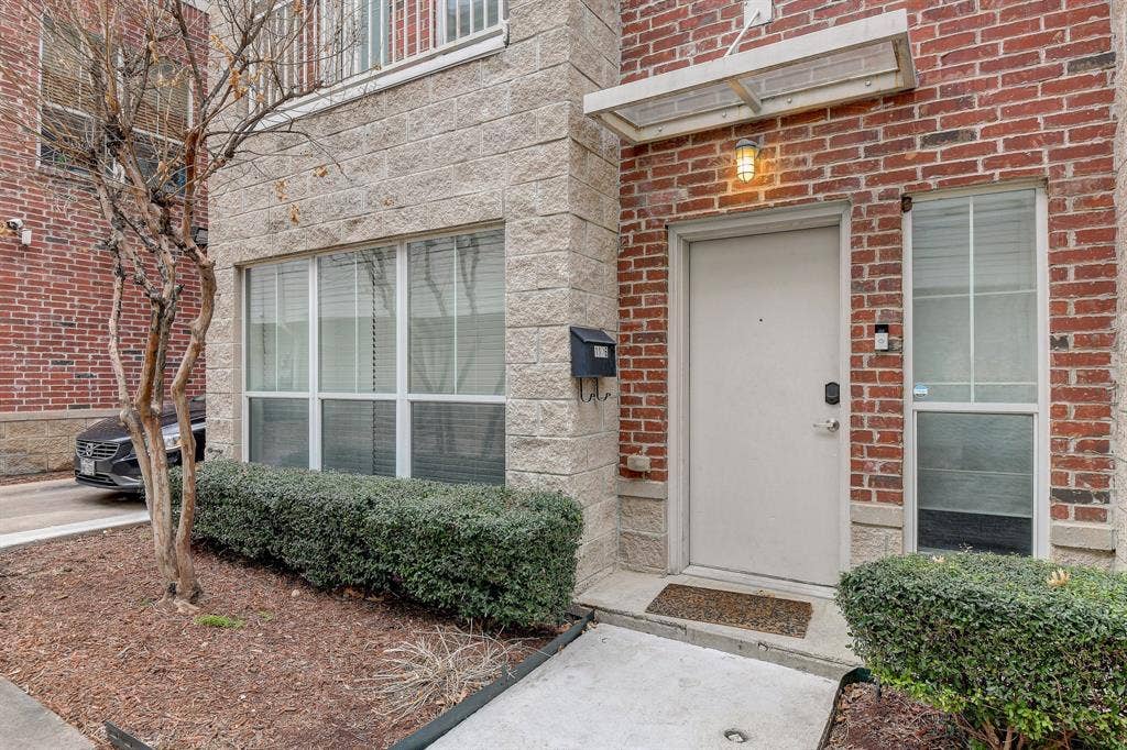 View of exterior entry with brick siding