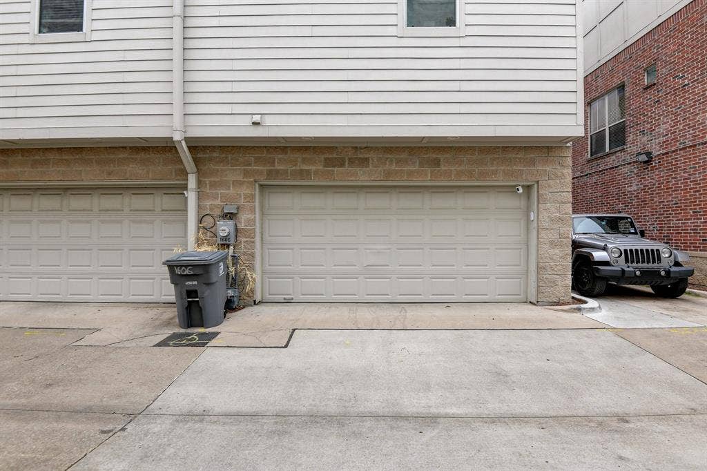 Garage featuring concrete driveway
