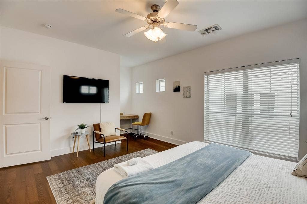Bedroom featuring wood finished floors, baseboards, and a ceiling fan