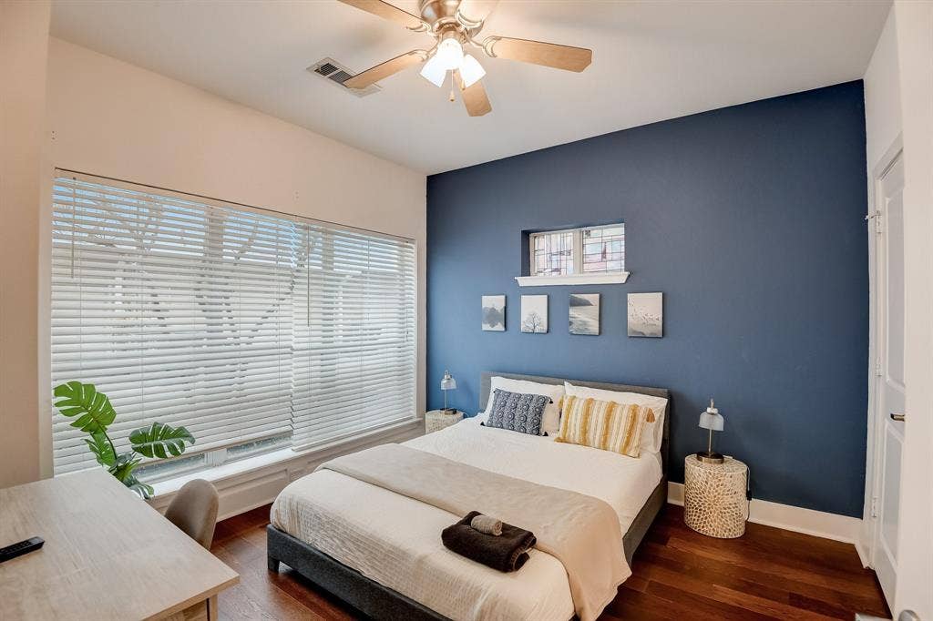Bedroom featuring wood finished floors, ceiling fan, and baseboards