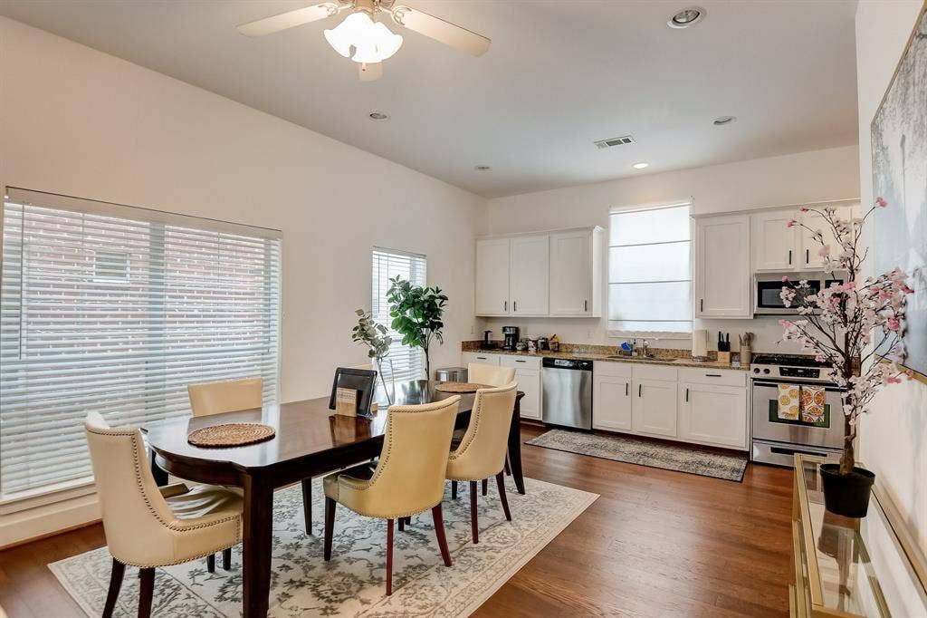 Dining area with plenty of natural light, dark wood-type flooring, a ceiling fan, and recessed lighting