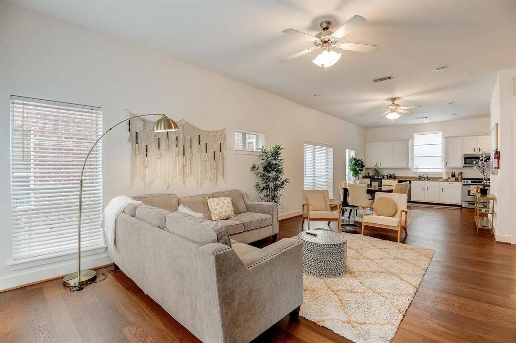 Living area featuring ceiling fan, dark wood finished floors, and baseboards